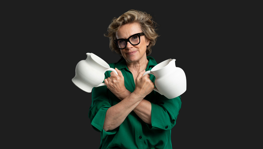 Portrait of Nadège Marini-Carriere holding two white Italian ceramic pitchers
