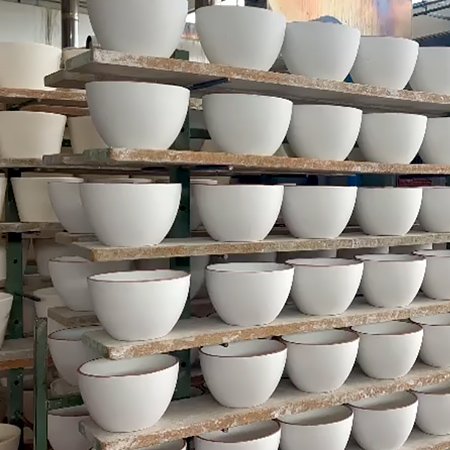 Rows of Mastrogiorgio handcrafted ceramic bowls drying in the workshop, traditionally made in Italy in Umbria.